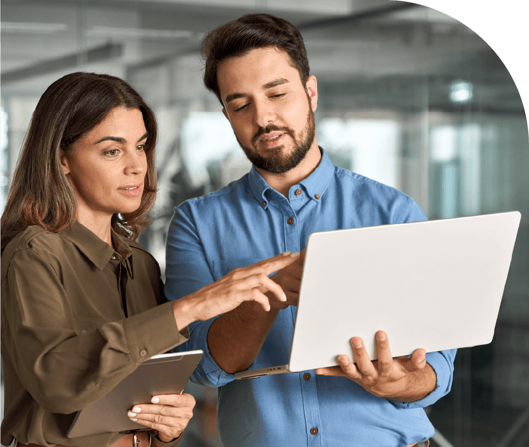 Business professionals reviewing resource planning data on a laptop
