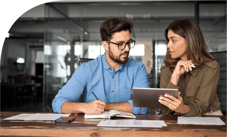 Managers comparing delivery reports and operational data to strengthen revenue forecasts