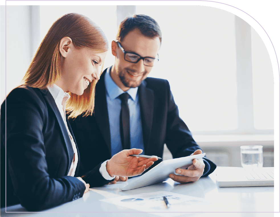 Business professionals reviewing workforce planning data on a tablet during a strategy meeting
