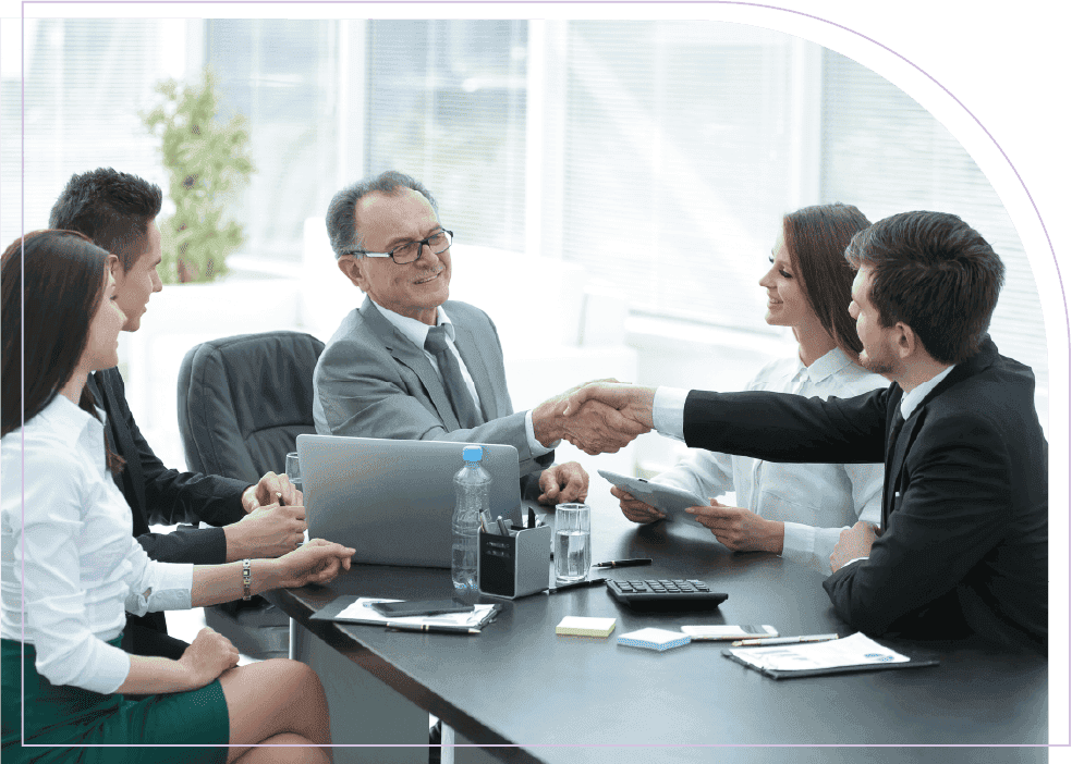 Business leaders shaking hands during a project coordination and delivery planning meeting