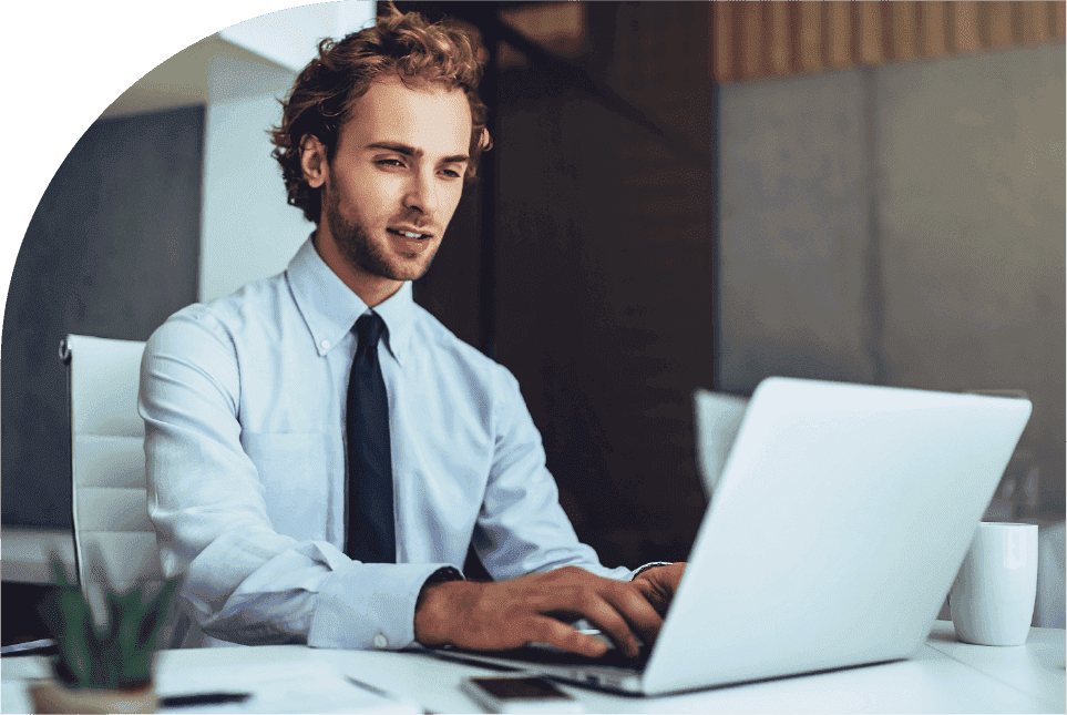 A project manager using a laptop to review project performance updates