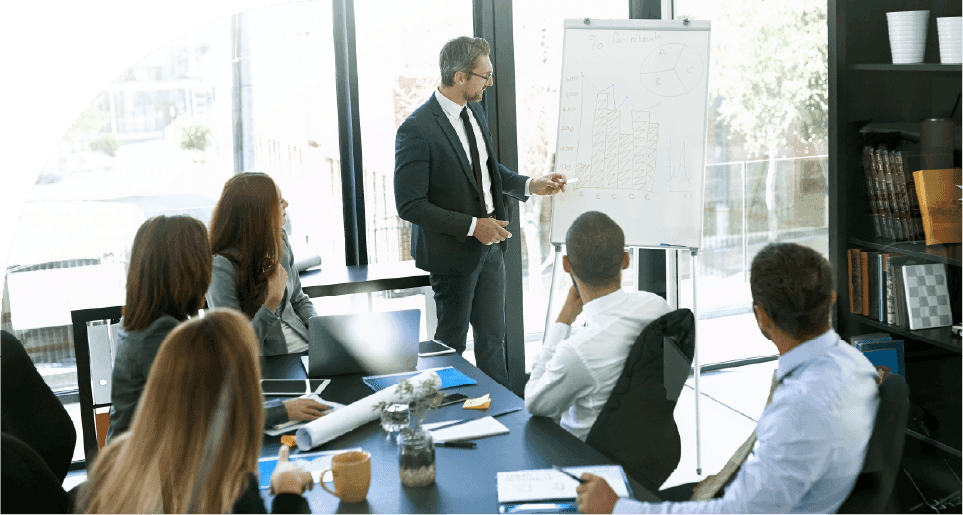 Professionals discussing SAVIOM’s training scheduling software capabilities